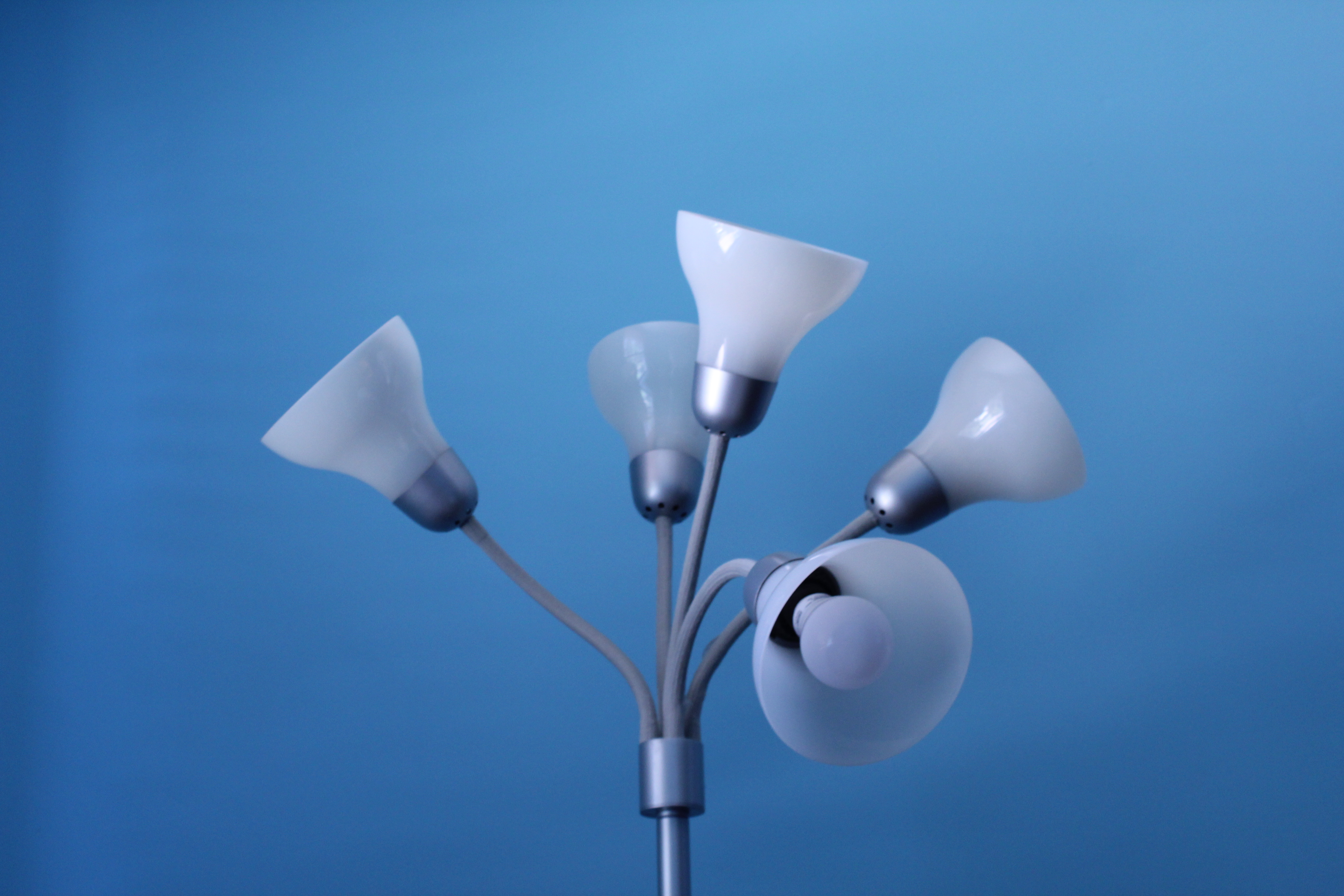 lamp with five lights in front of blue background