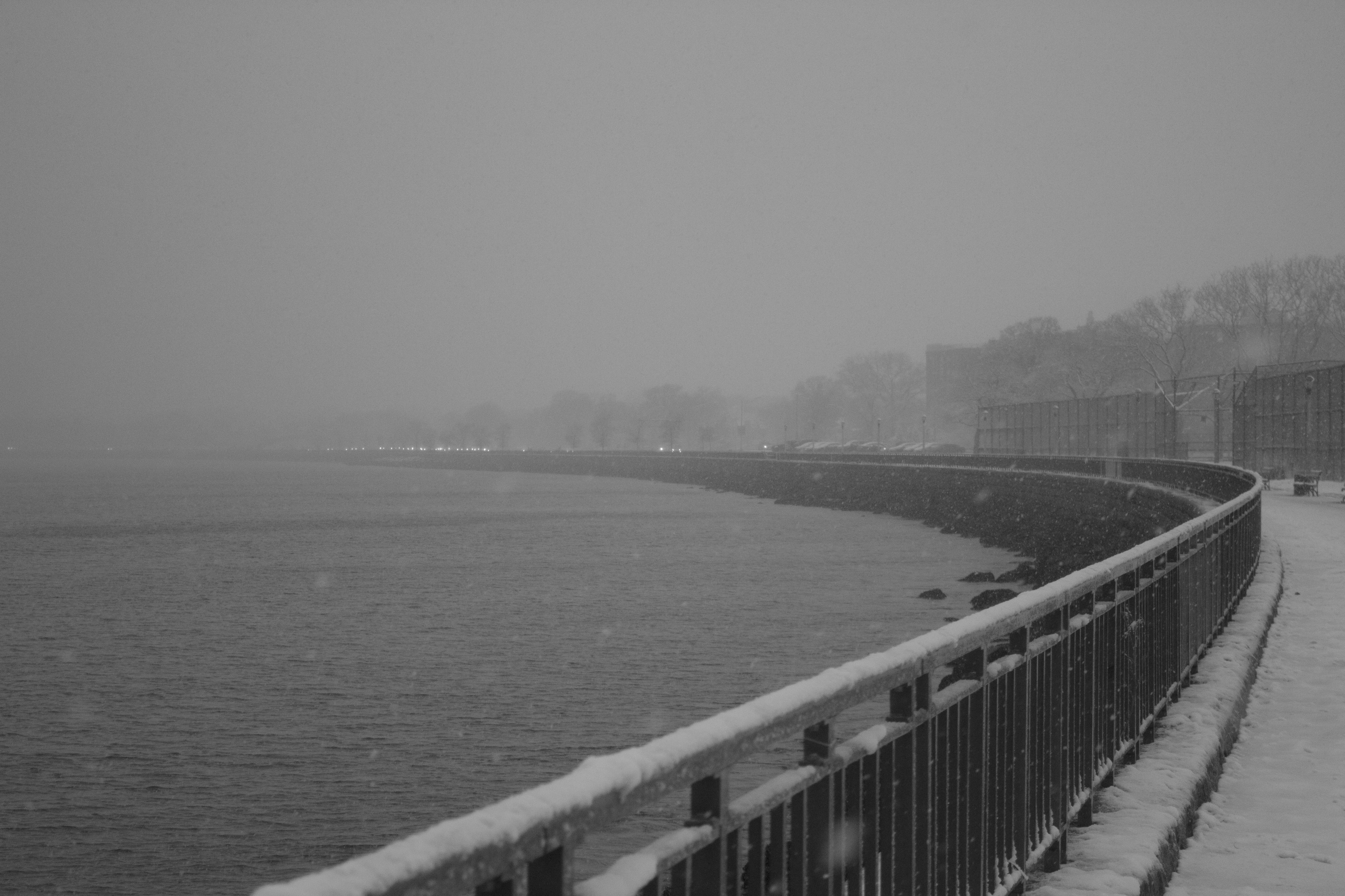 grey winter road near water