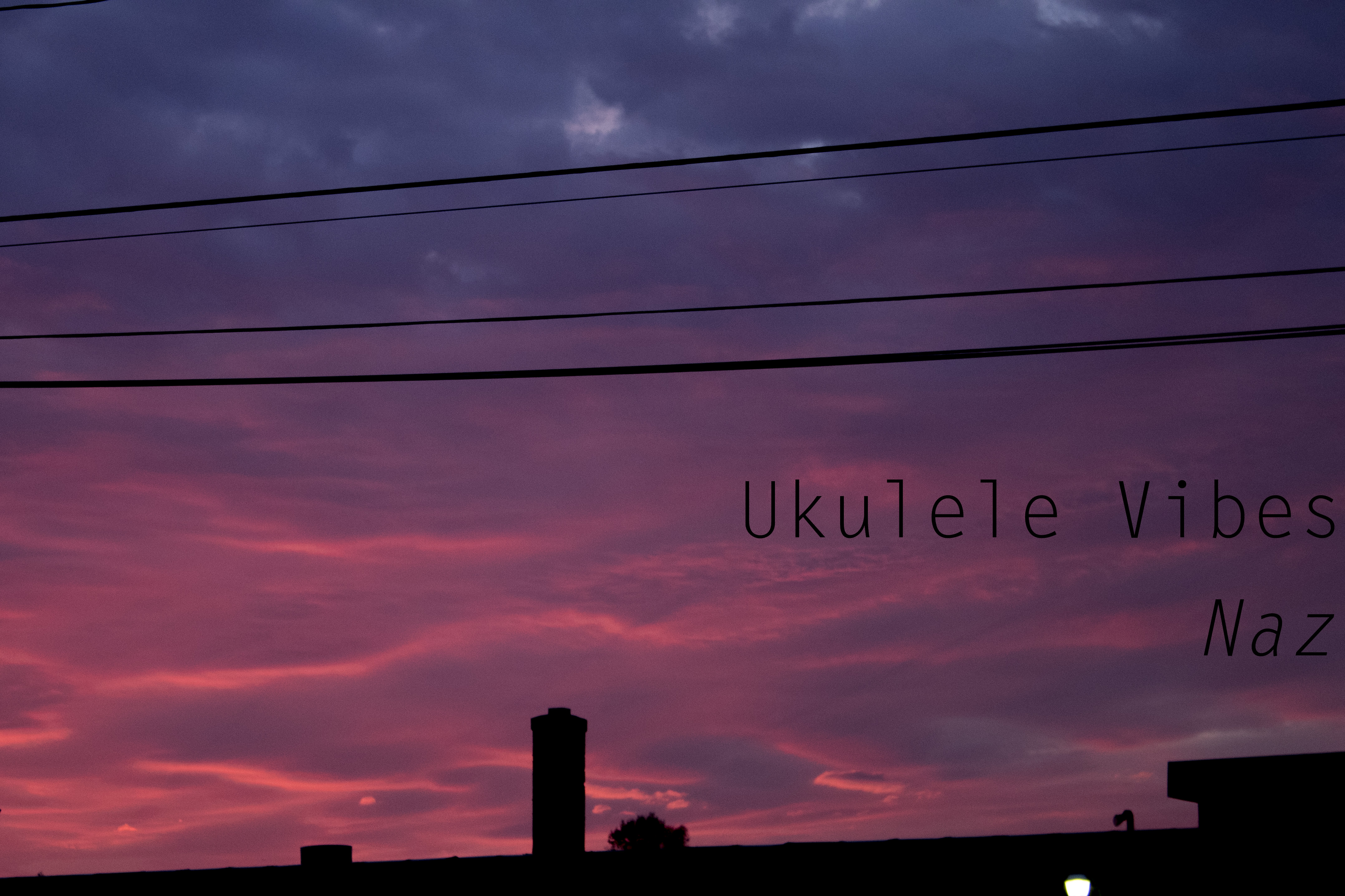blue and pink sky with silhouette of houses at the bottom